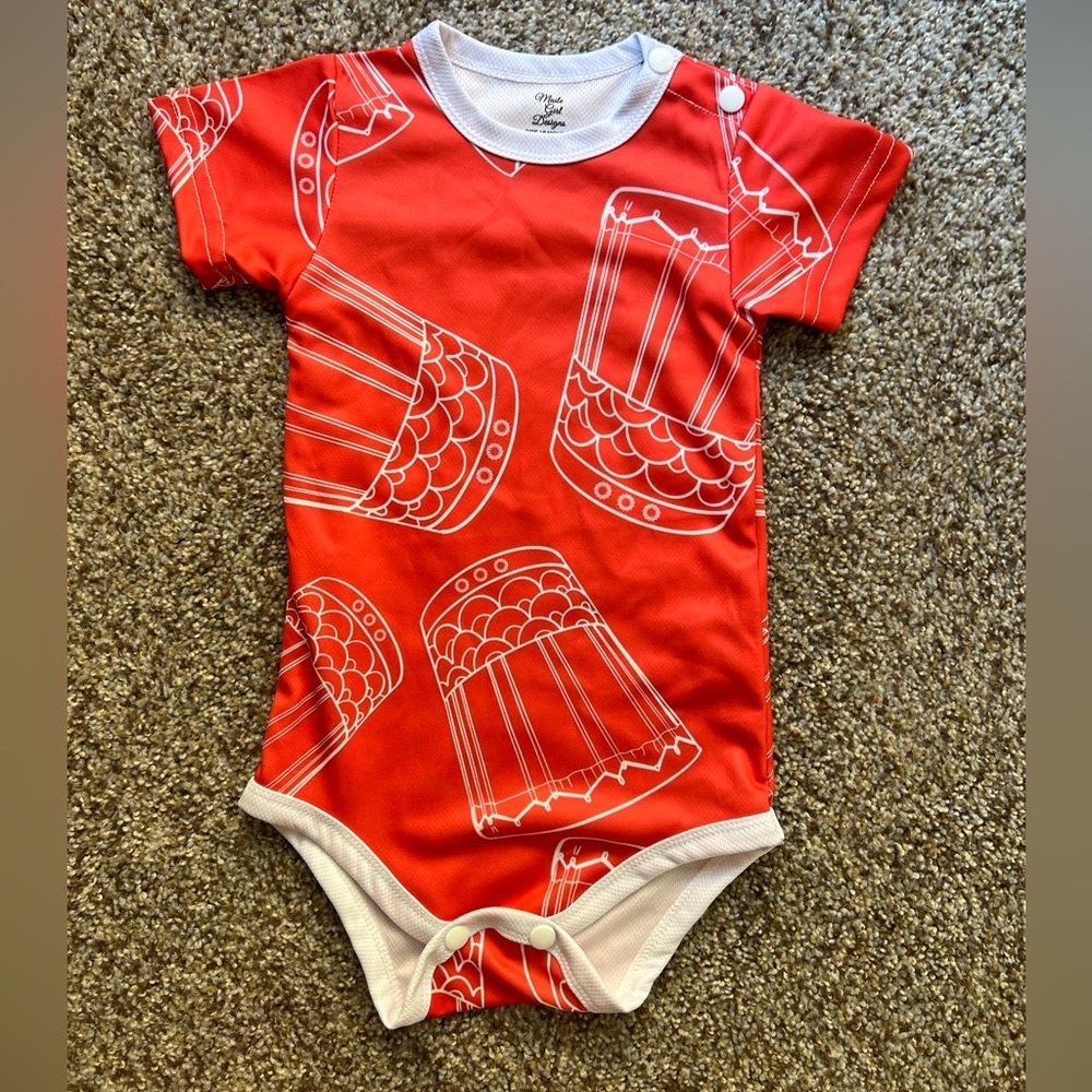 Maile Girl Designs "KUPAHU" print on baby onesies.